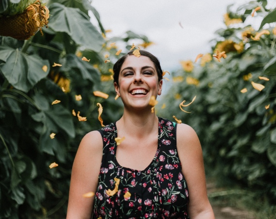 Woman smiling in a field of flowers